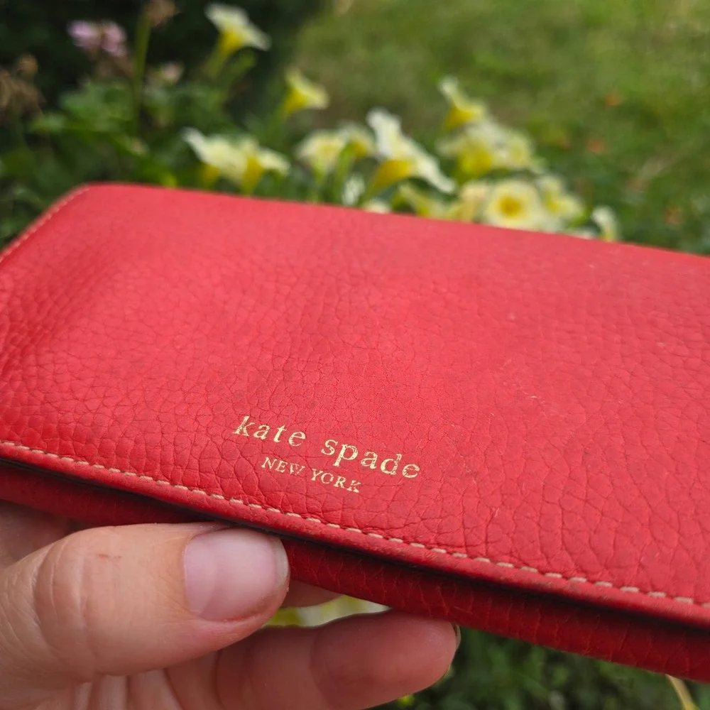kate spade bifold pebble leather wallet. In red. Flaws